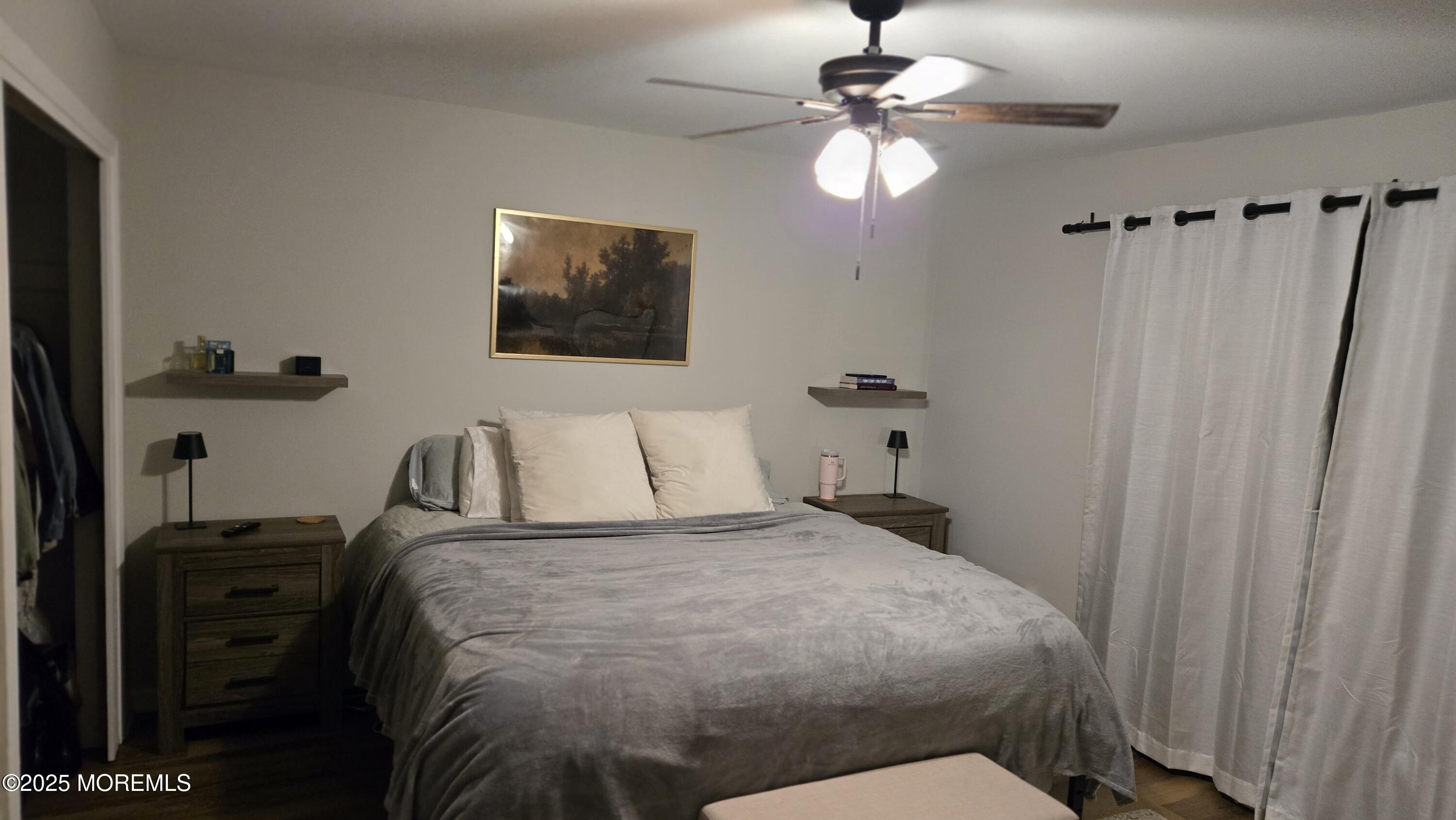 3 Primrose Lane Brick, NJ 08724 - Photo 6 of 8 a bedroom with a bed and a chandelier