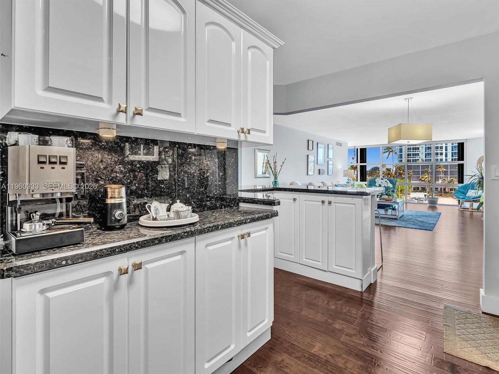 6423 Collins Avenue, Unit 409 Miami Beach, FL 33141 - Photo 11 of 61 a kitchen with stainless steel appliances granite countertop a stove a sink and white cabinets