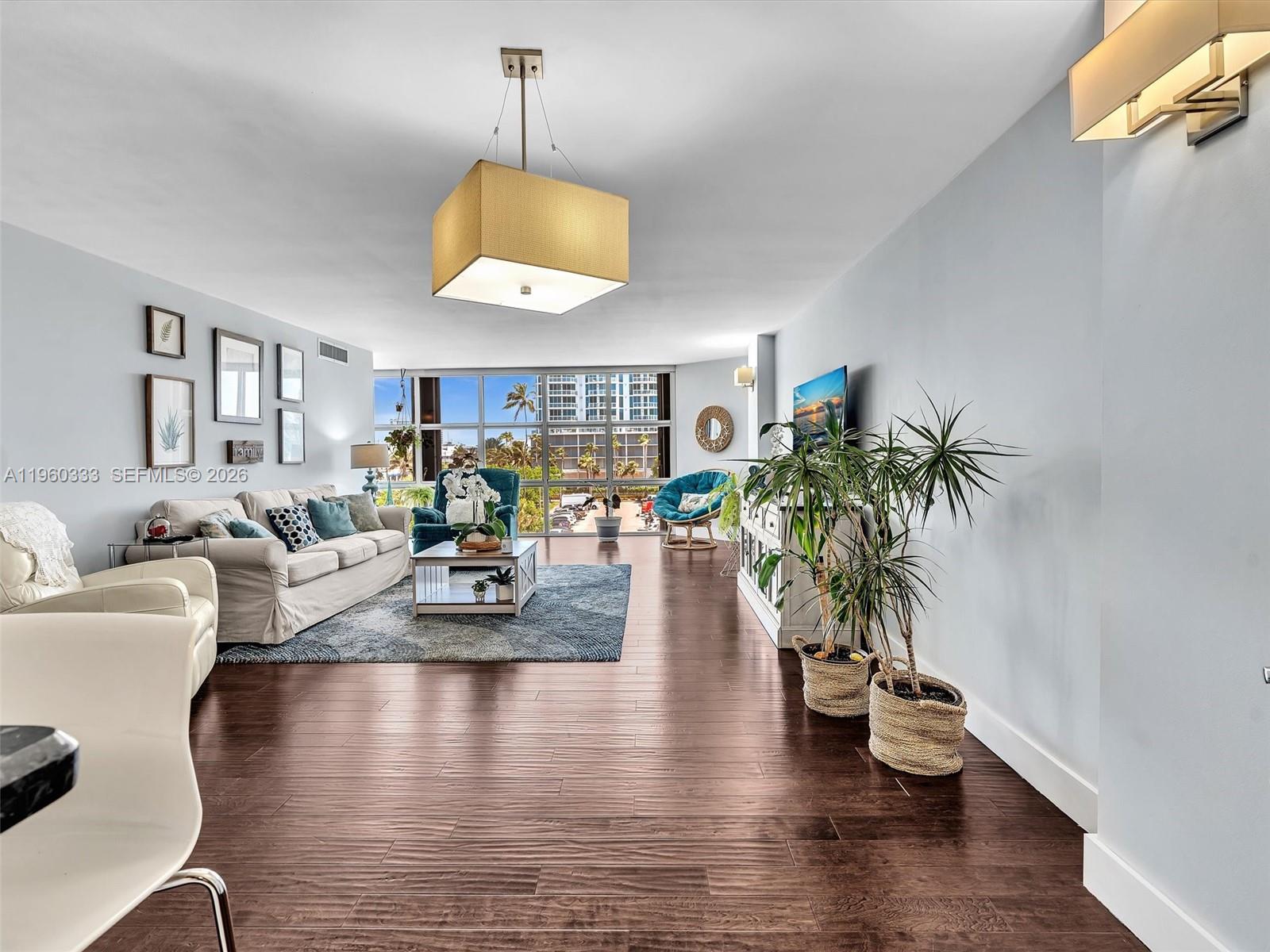 6423 Collins Avenue, Unit 409 Miami Beach, FL 33141 - Photo 12 of 61 a living room with fireplace furniture and a wooden floor