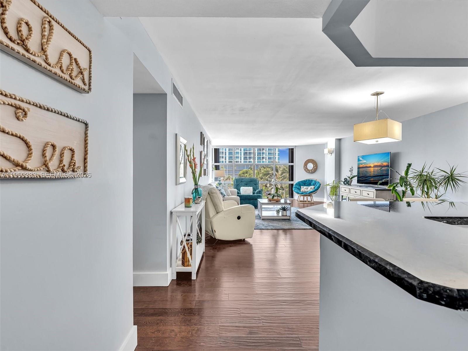 6423 Collins Avenue, Unit 409 Miami Beach, FL 33141 - Photo 2 of 61 a living room with furniture and a wooden floor