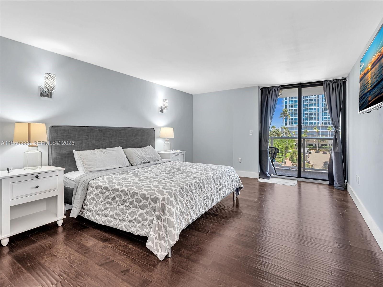 6423 Collins Avenue, Unit 409 Miami Beach, FL 33141 - Photo 28 of 61 a bedroom with a large bed and a large window