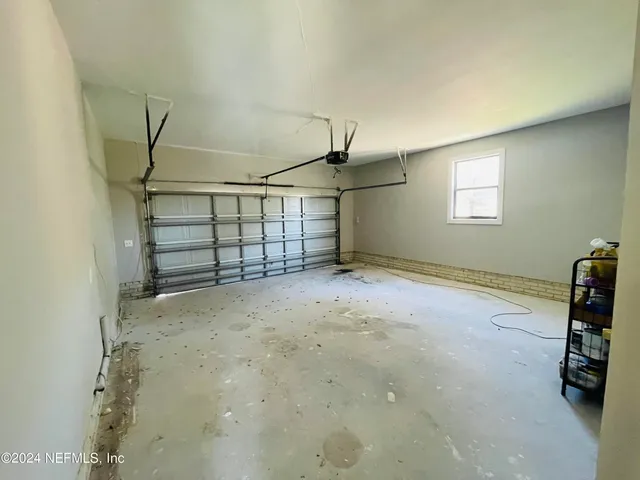 a view of a backyard with potted plants and large tree