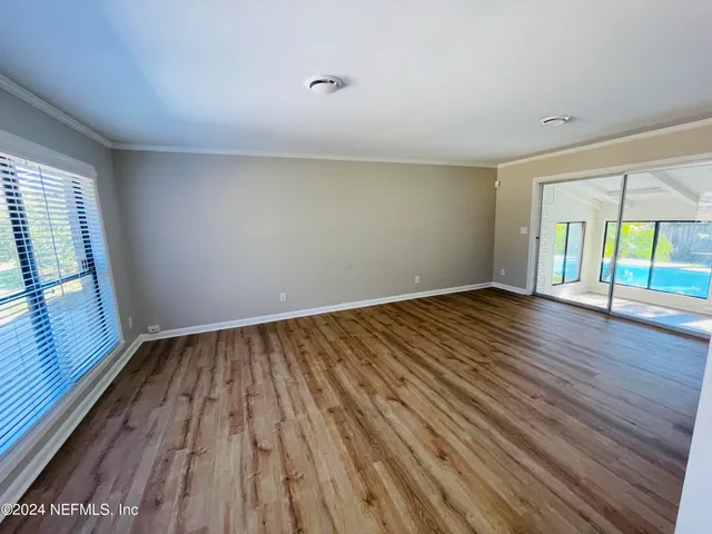 wooden floor in an empty room with a window