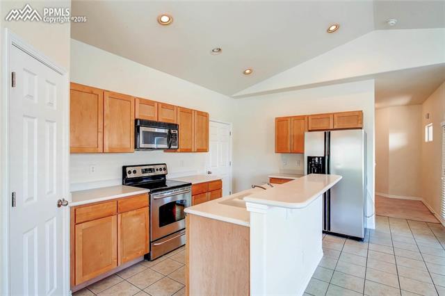 724 Rye Ridge Road Fountain, CO 80817 - Photo 5 of 8 Tiled Kitchen with large pantry.