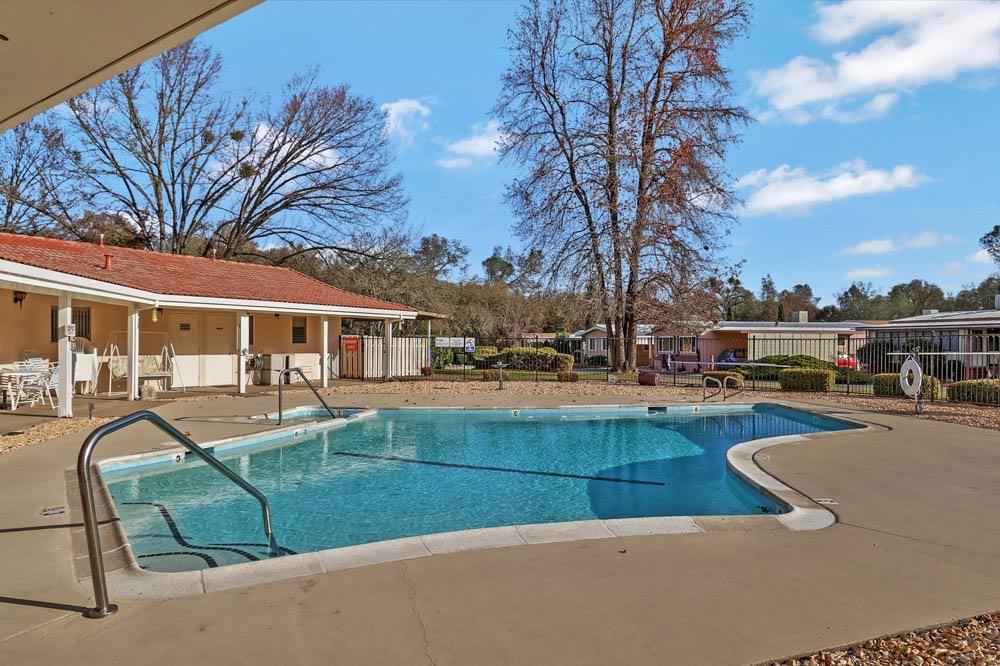 1330 Calaveritas Road, Unit 25 San Andreas, CA 95249 - Photo 39 of 43 a view of swimming pool with outdoor seating and covered with trees