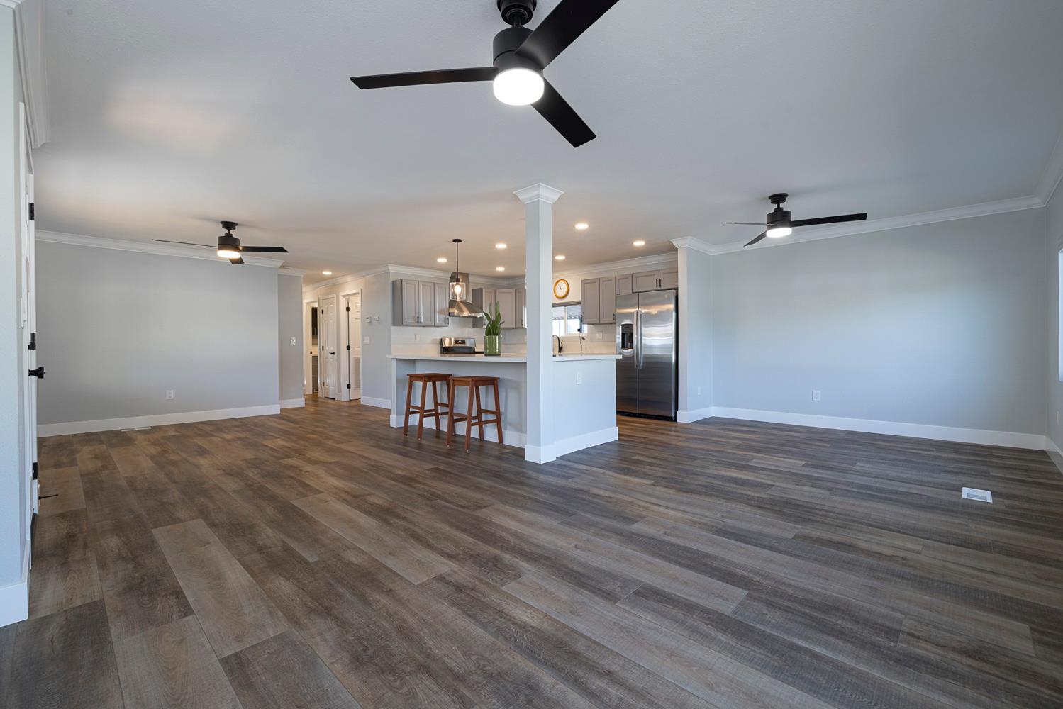 1330 Calaveritas Road, Unit 25 San Andreas, CA 95249 - Photo 9 of 43 wooden floor in an empty room with a kitchen