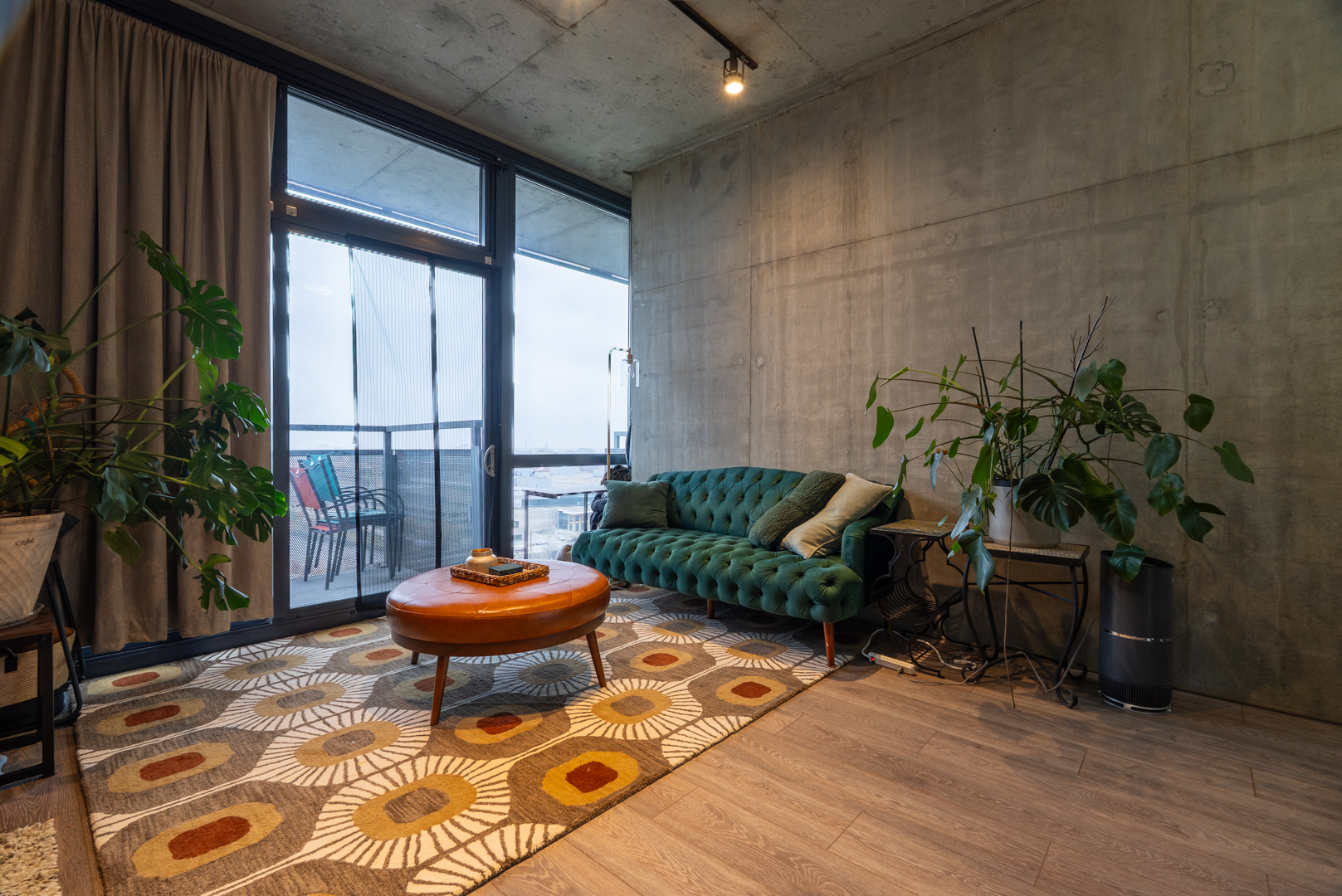 235 West Van Buren Street, Unit 1809 Chicago, IL 60607 - Photo 12 of 17 a living room with a couch and a potted plant