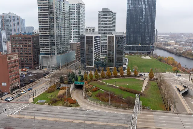 a view of a balcony with two chairs and a potted plant