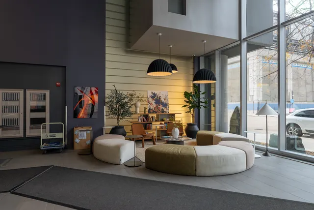 a living room with furniture and a floor to ceiling window