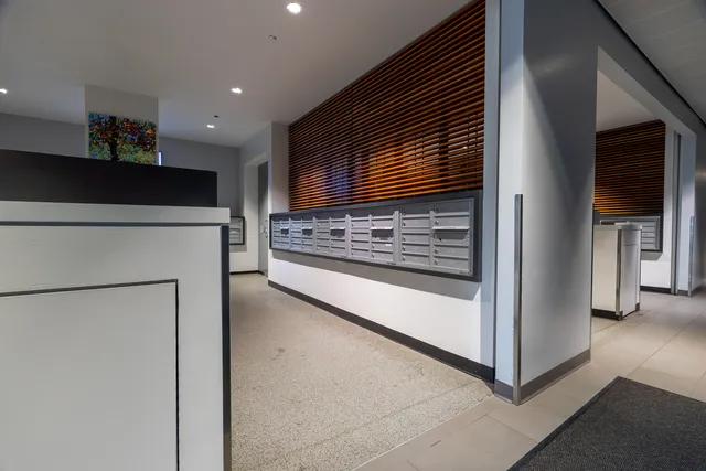 a view of kitchen with refrigerator and cabinets