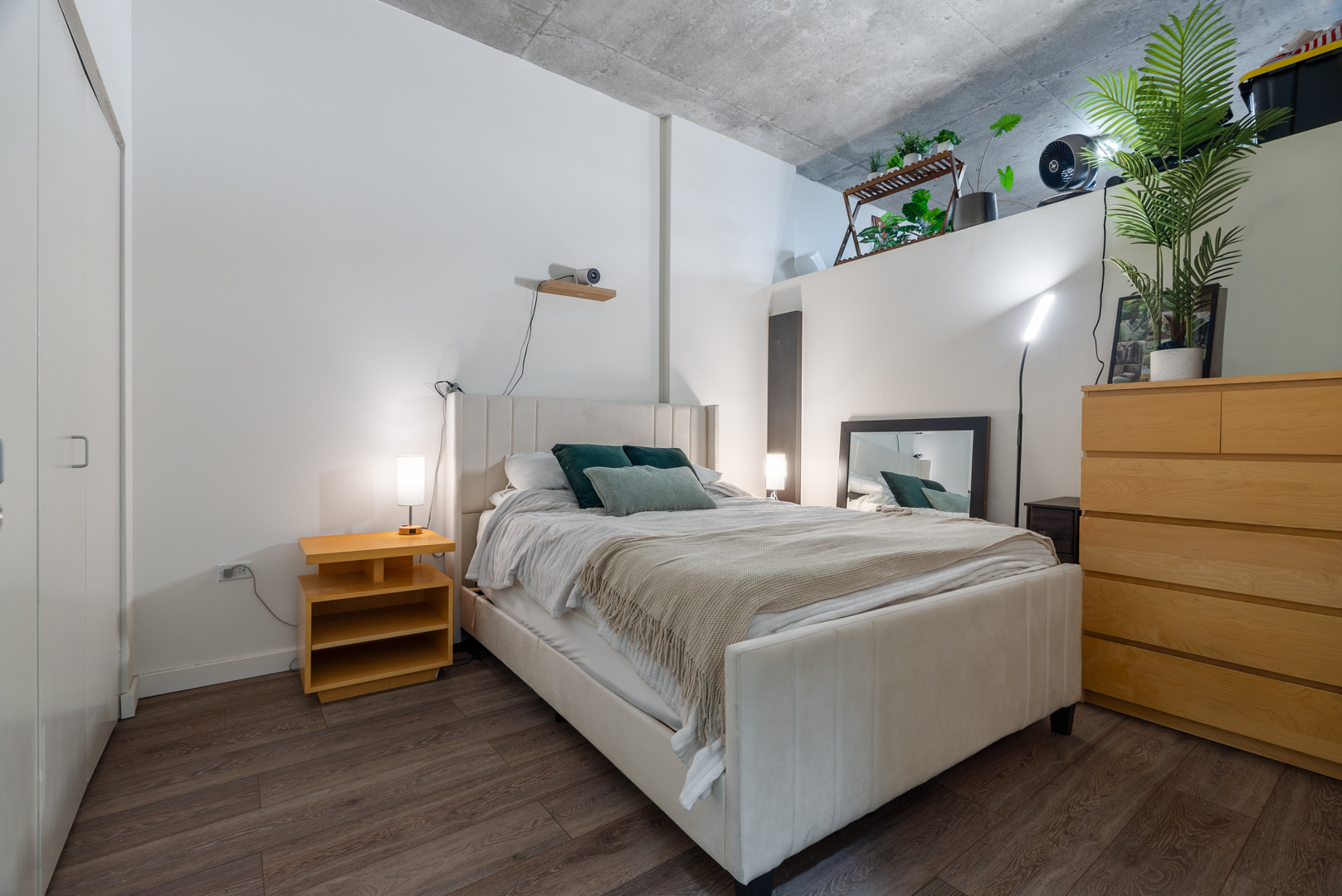 235 West Van Buren Street, Unit 1809 Chicago, IL 60607 - Photo 9 of 17 a bedroom with a bed and a potted plant