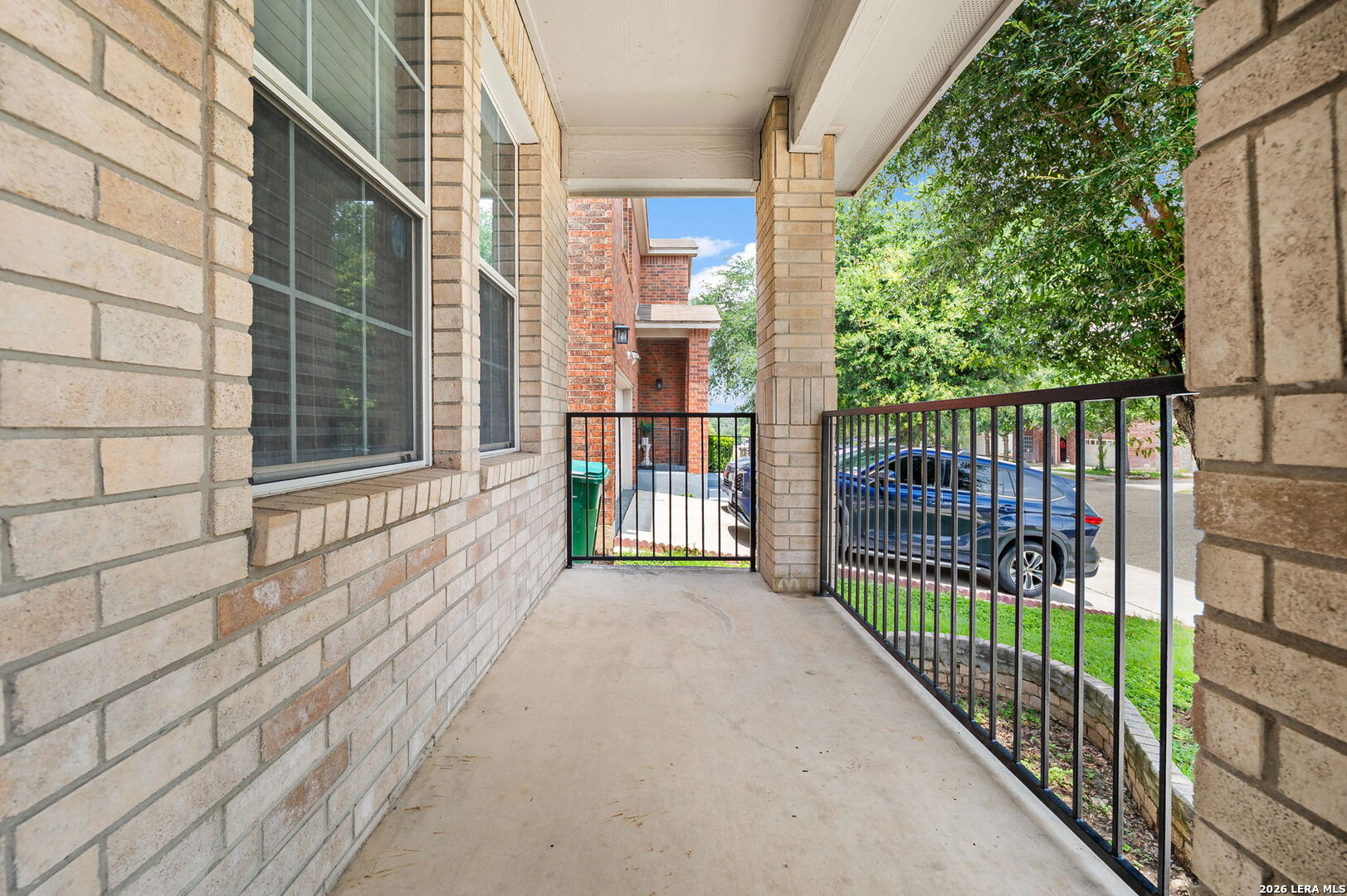 7207 Avery Road Live Oak, TX 78233 - Photo 4 of 32 a view of a balcony with a floor to ceiling window and wooden floor