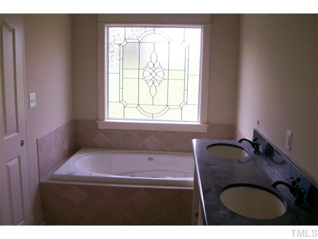 84 South Sunset Ridge Drive Willow Spring, NC 27592 - Photo 13 of 21 a bathroom with a granite countertop sink and a mirror