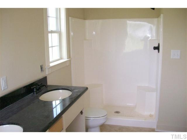 84 South Sunset Ridge Drive Willow Spring, NC 27592 - Photo 14 of 21 a bathroom with a granite countertop sink toilet and a mirror