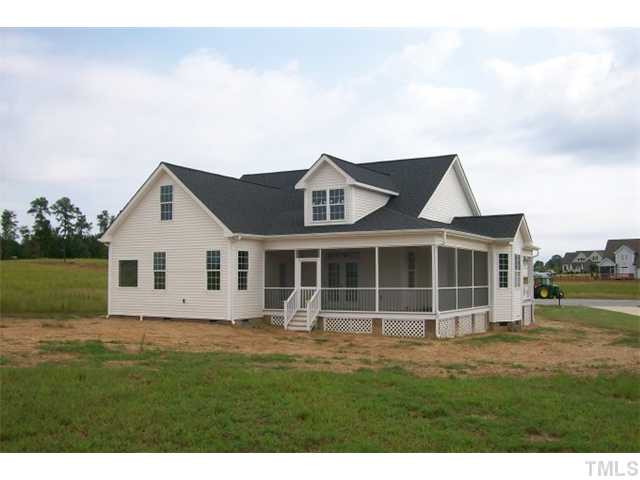 84 South Sunset Ridge Drive Willow Spring, NC 27592 - Photo 2 of 21 a front view of a house with a garden