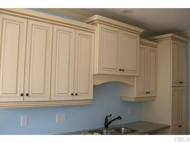 84 South Sunset Ridge Drive Willow Spring, NC 27592 - Photo 4 of 21 a view of kitchen with white cabinets and wooden floor
