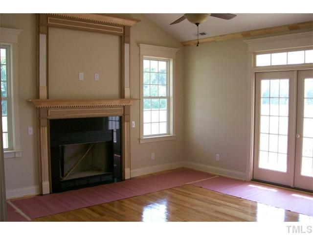 84 South Sunset Ridge Drive Willow Spring, NC 27592 - Photo 8 of 21 a view of an empty room with wooden floor and a window