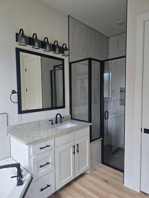 808 N Avenue East Springtown, TX 76082 - Photo 7 of 21 a bathroom with a granite countertop sink and a mirror