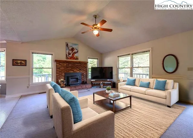 a living room with fireplace furniture and a flat screen tv