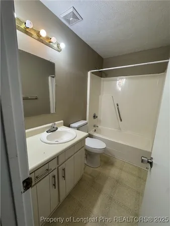 a bathroom with a sink and mirror with toilet