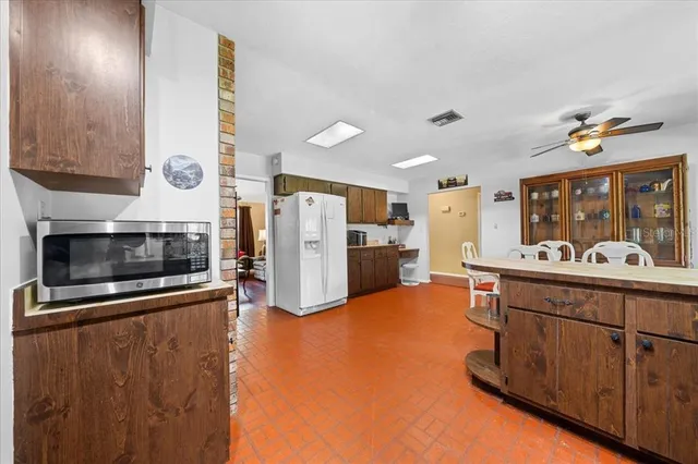 a kitchen with stainless steel appliances granite countertop a sink and a refrigerator