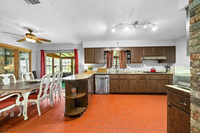 a kitchen with a sink appliances and cabinets
