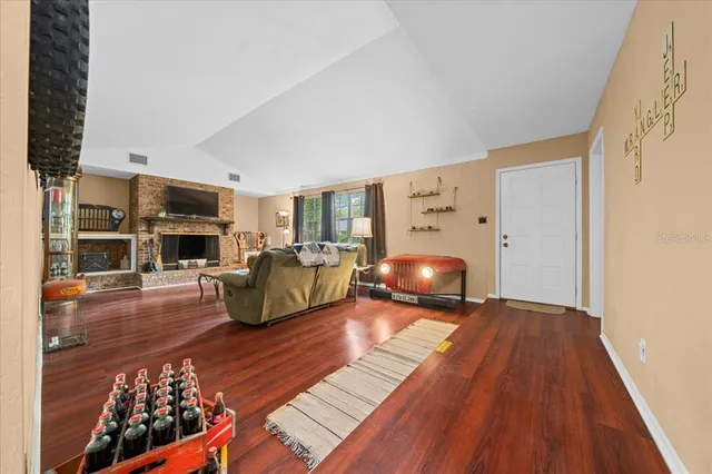 a bedroom with furniture and a wooden floor