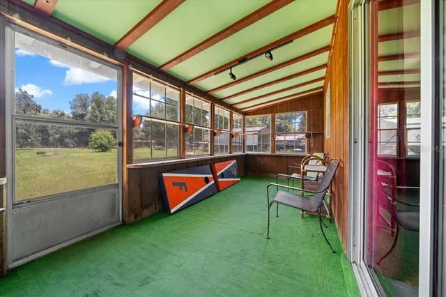 a view of a house with a yard and sitting area