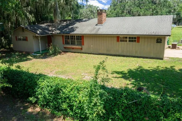a view of a house with a yard and sitting area