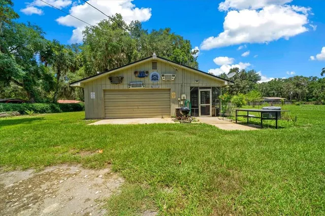 a view of a chair and table in the garden in the back