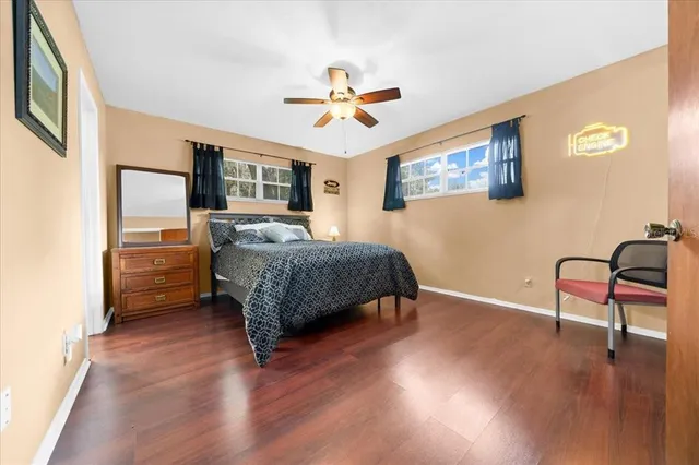 a bedroom with a bed and a chair