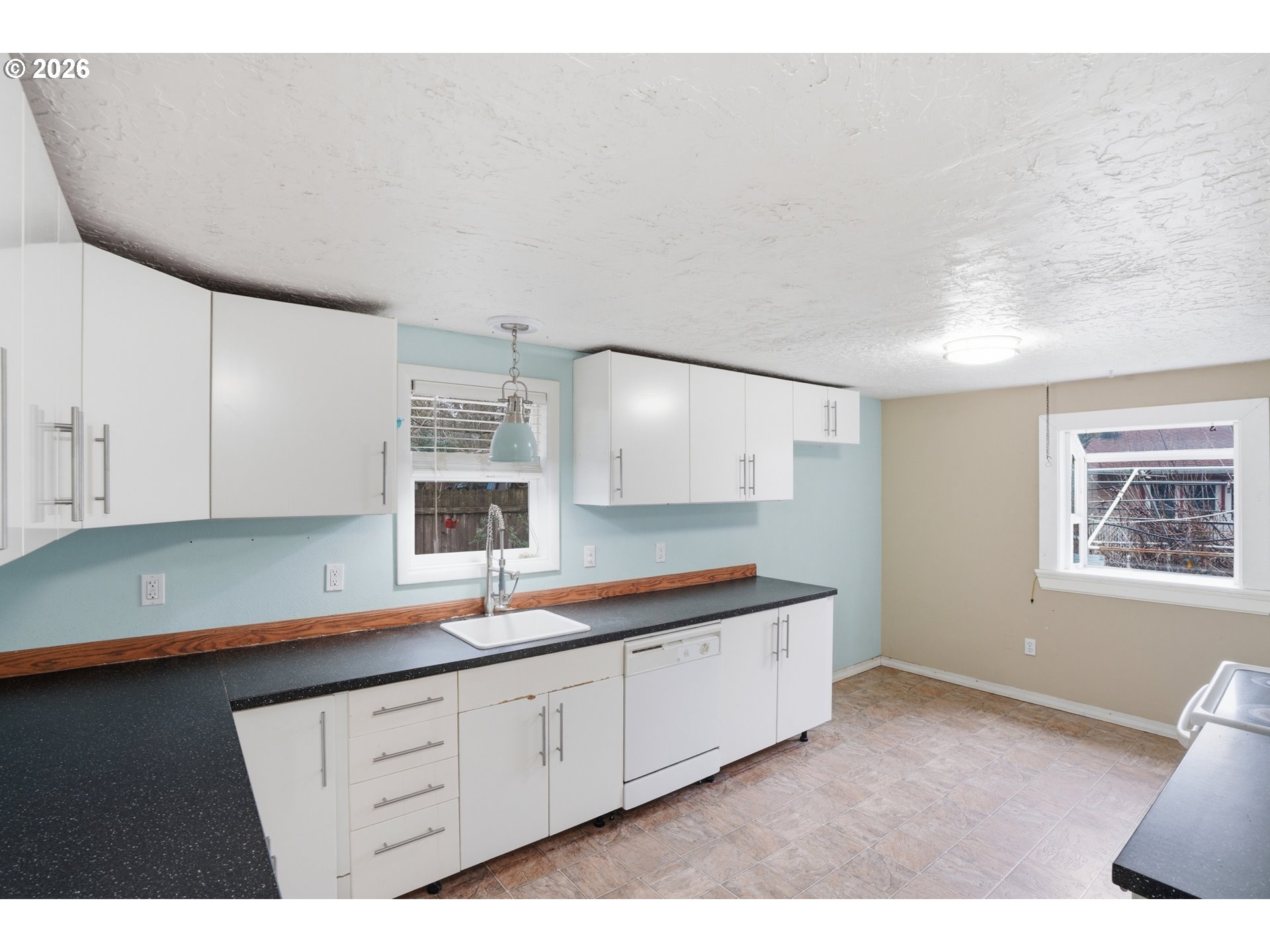 40 Southeast 133rd Avenue, Unit B Portland, OR 97233 - Photo 11 of 24 a kitchen with sink and cabinets
