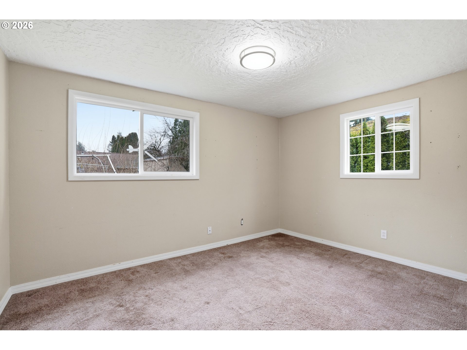 40 Southeast 133rd Avenue, Unit B Portland, OR 97233 - Photo 14 of 24 an empty room with windows