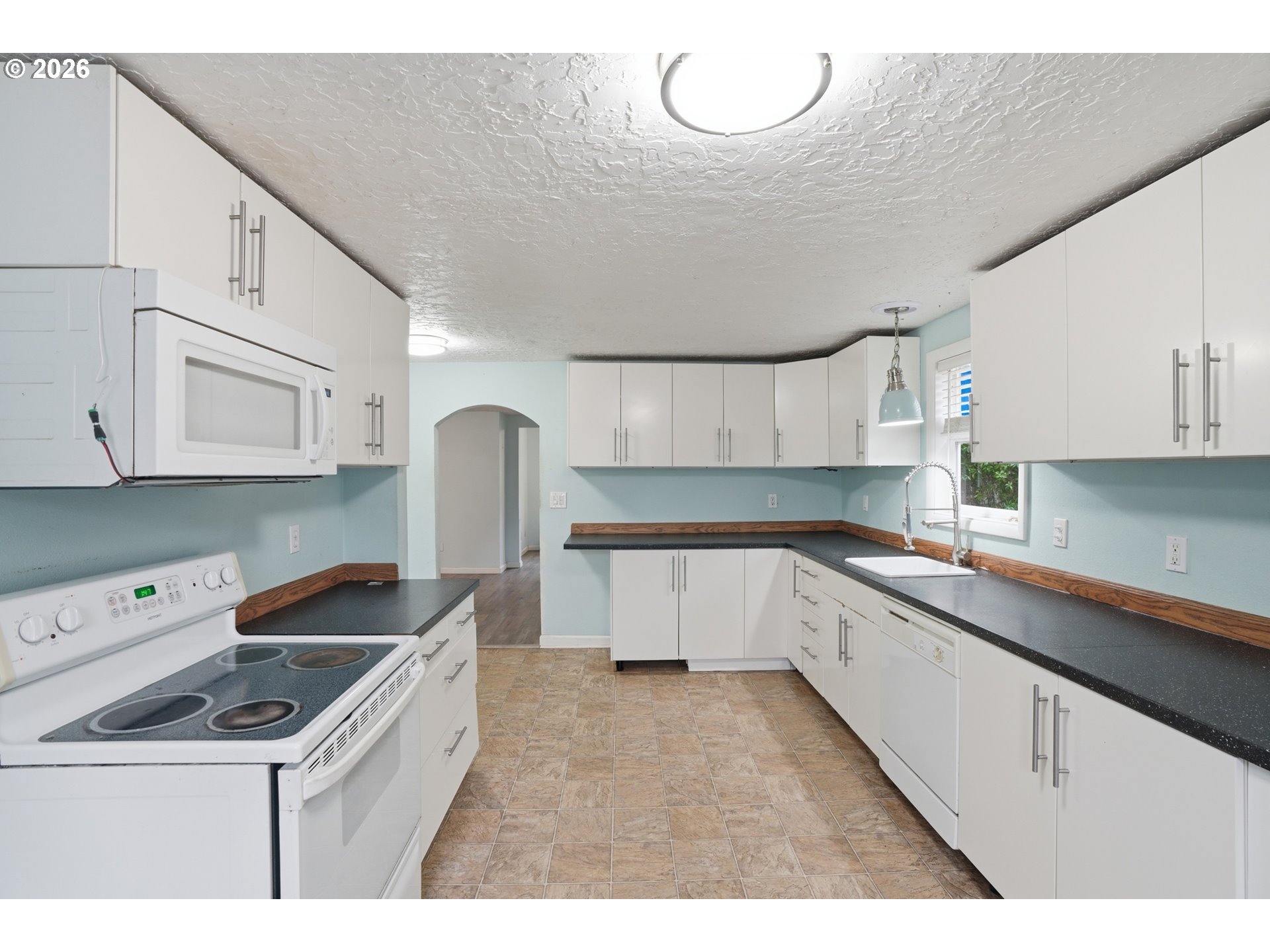 40 Southeast 133rd Avenue, Unit B Portland, OR 97233 - Photo 8 of 24 a kitchen that has a sink and cabinets in it