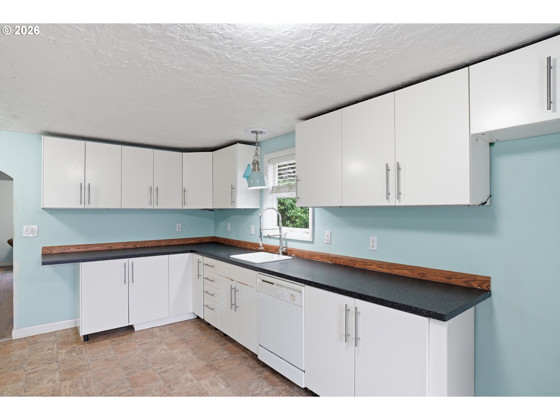 40 Southeast 133rd Avenue, Unit B Portland, OR 97233 - Photo 9 of 24 a kitchen with sink cabinets and window