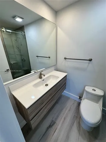 a bathroom with a sink toilet and mirror