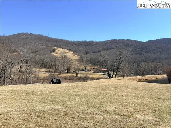 a view of white house with a yard