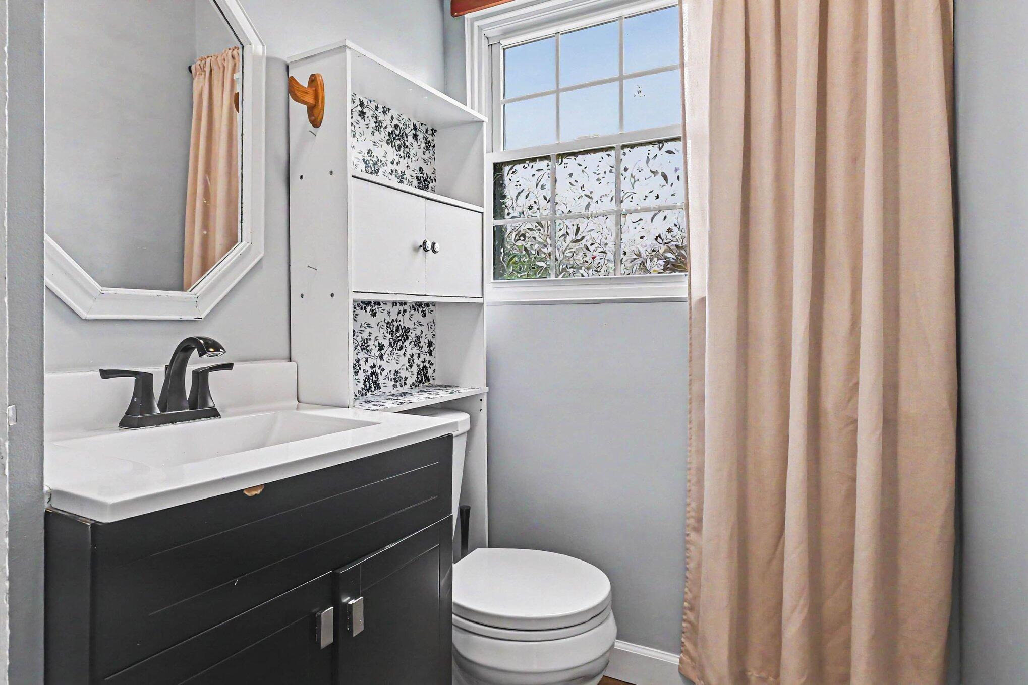 115 McClung Road La Porte, IN 46350 - Photo 14 of 31 a bathroom with a sink a toilet and a mirror