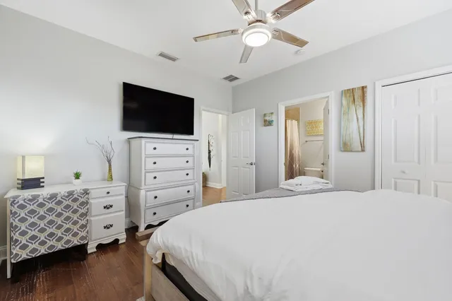 a bathroom with a granite countertop sink mirror vanity and toilet