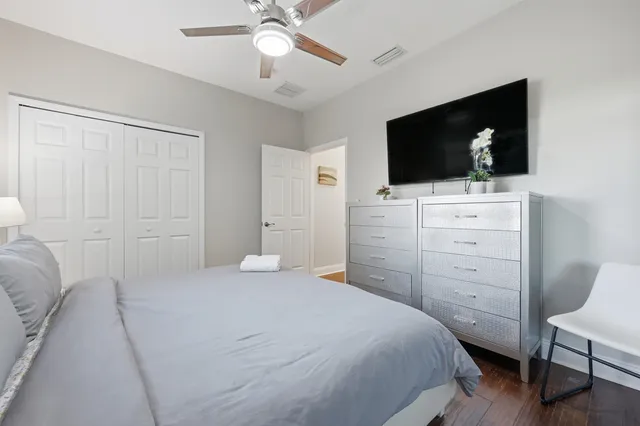 a bedroom with furniture and a wooden floor