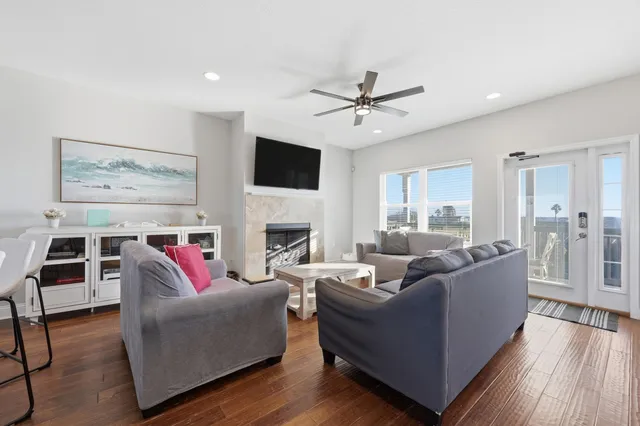 a living room with furniture kitchen view and a fireplace