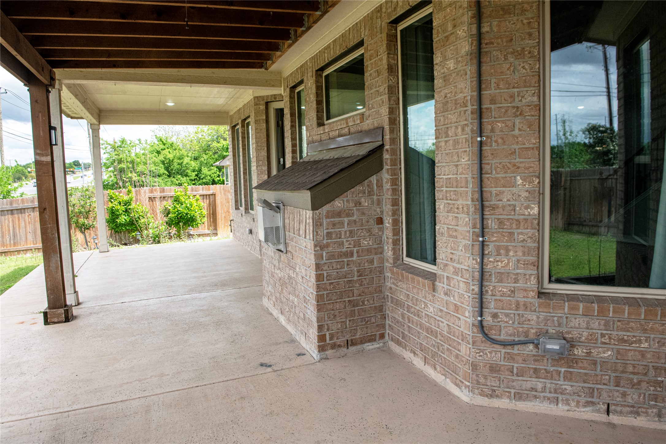 2260 Hat Bender Loop Round Rock, TX 78664 - Photo 25 of 40 a view of a porch with a floor to ceiling window and wooden floor