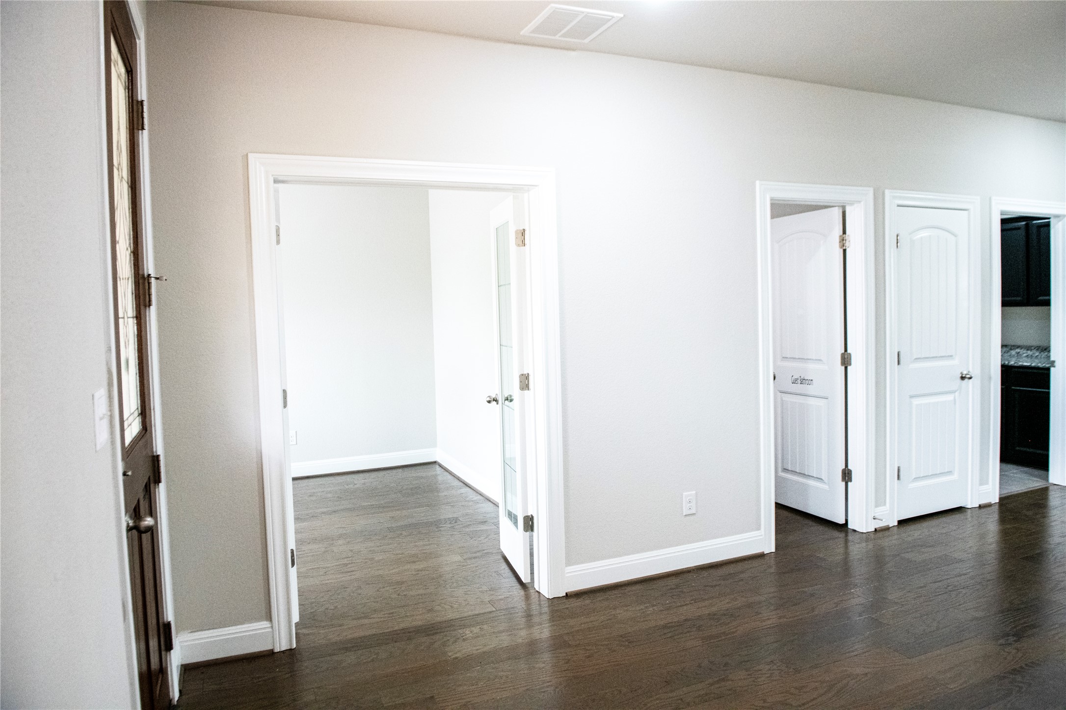2260 Hat Bender Loop Round Rock, TX 78664 - Photo 3 of 40 an empty room with wooden floor and entrance