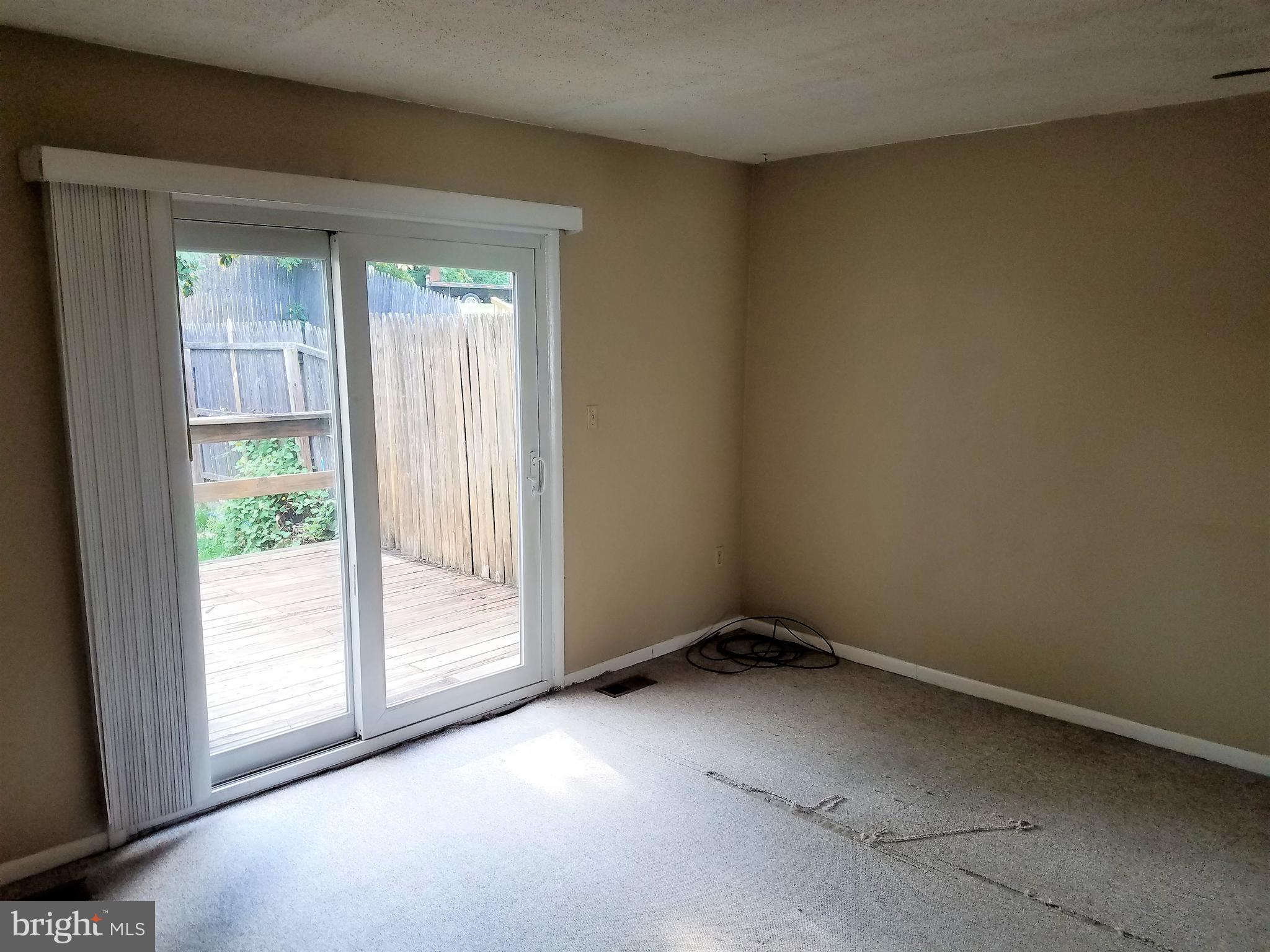 8906 Trimble Way Rosedale, MD 21237 - Photo 3 of 25 Living Room w/ Sliding Door Access to Rear Lawn