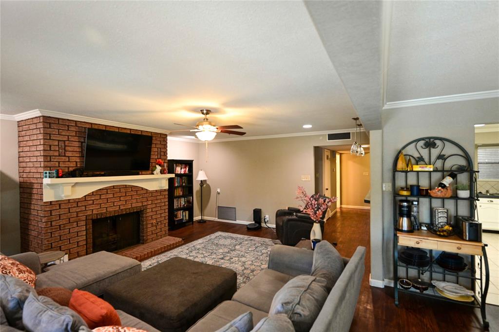 32 Rue Maison Abilene, TX 79605 - Photo 1 of 40 a living room with furniture a flat screen tv and a fireplace