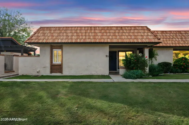 a front view of a house with a garden
