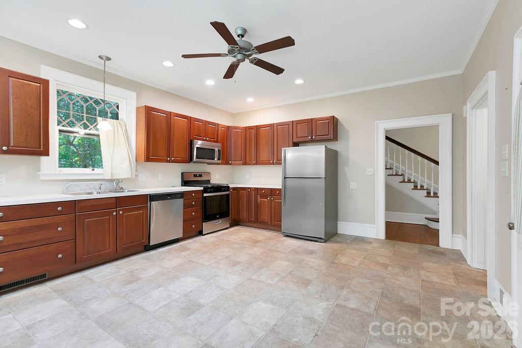 208 West Probart Street Brevard, NC 28712 - Photo 25 of 48 a kitchen with stainless steel appliances granite countertop a refrigerator a sink dishwasher a stove with cabinets and wooden floor