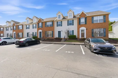 a car parked in front of a white building