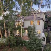 aerial view of a house with a yard and potted plants