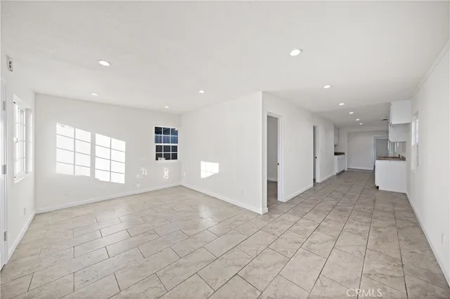 a view of a hallway with a white cabinets